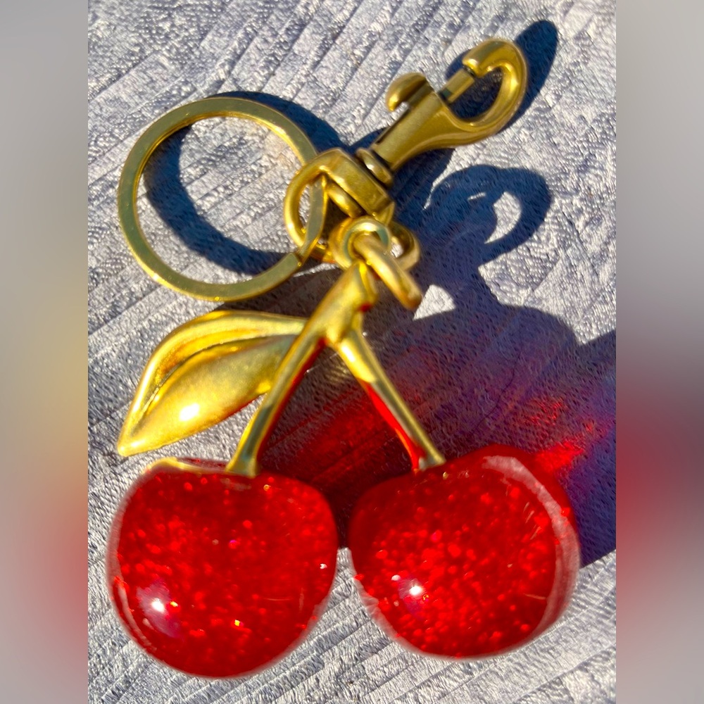 Cherries keychain bag charm. Coach like fashion, unbranded. New. Red and gold.